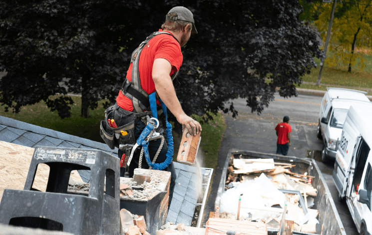 Crew member removing junk from a rooftop